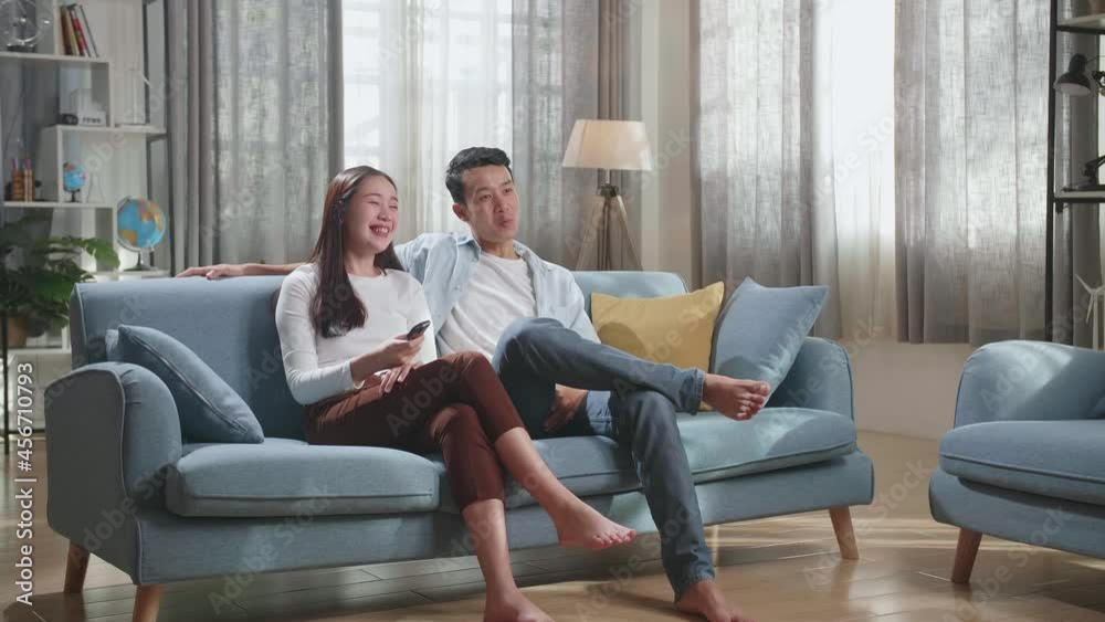 Happy Young Asian Couple Relaxing And Watching Tv At Home
Happy Young Asian Couple Relaxing And Watching Tv At Home