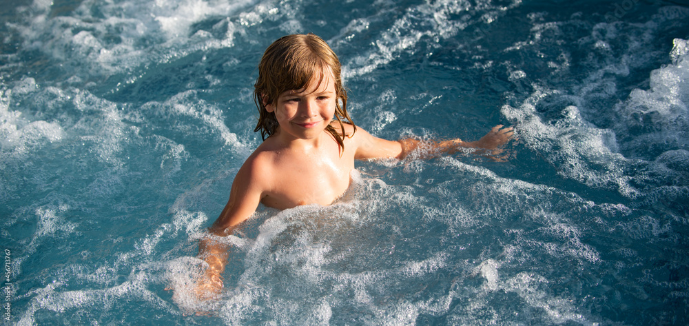 Funny child enjoying the summer in the pool.