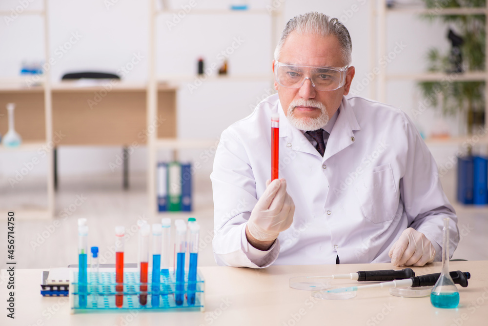 Old male chemist working in the lab Old male chemist working in the lab