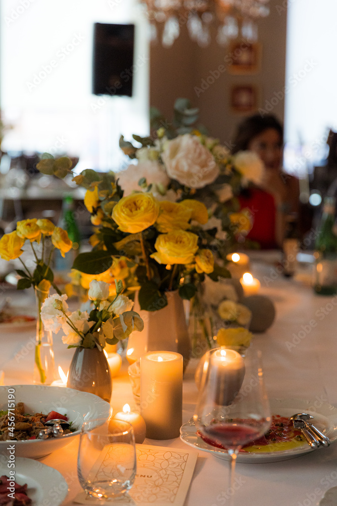 Dinner set with yellow roses for a festive candlelight party