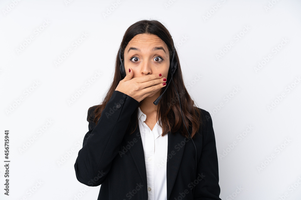 Young telemarketer woman isolated on white background covering mouth with hands Young telemarketer woman isolated on white background covering mouth with hands