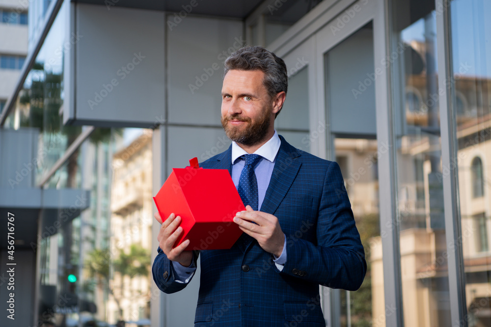 Businessman outdoor with shopping bags. Handsome man wit birthday present. Anniversary celebration. Holiday greetings. Gift shop. - obrazy, fototapety, plakaty 