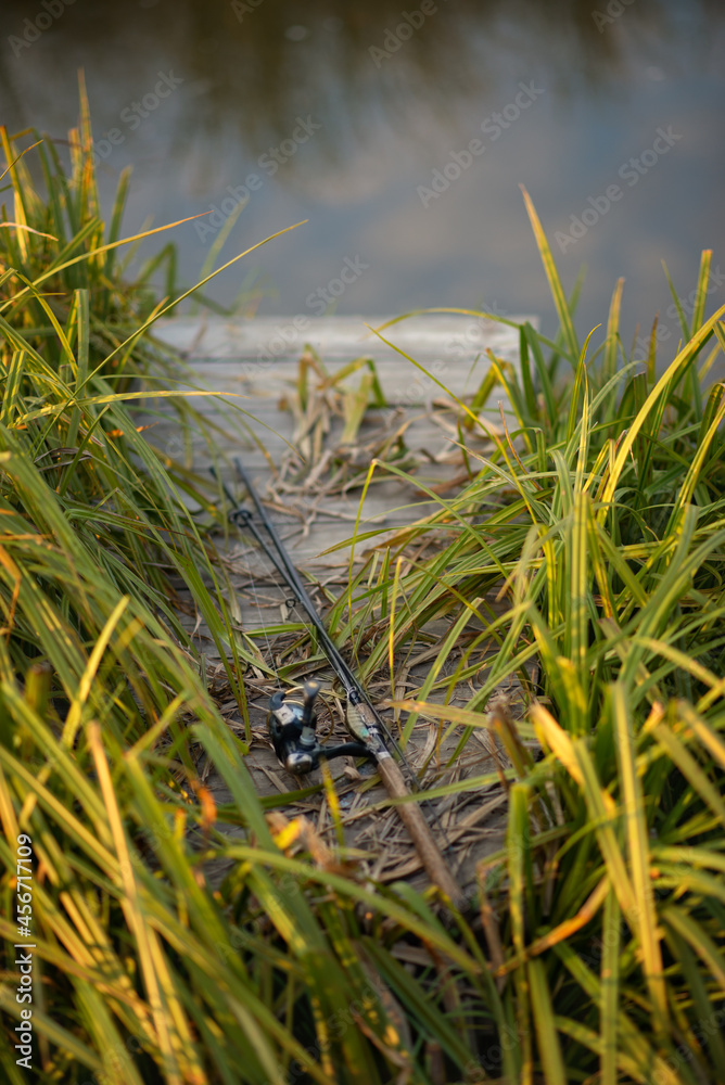 Obraz premium Photo of a fishing rod near the lake.