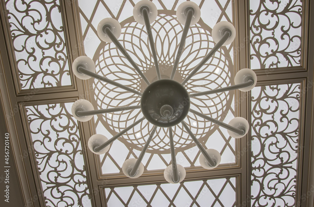 carved ceiling with lighting in light colors