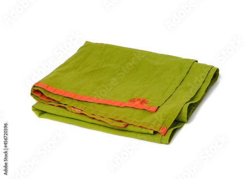 folded green linen towel on white background, top view