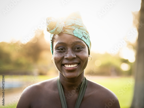 happy African woman wearing colorful traditional turban - .Afro black culture and tradition concept photo
