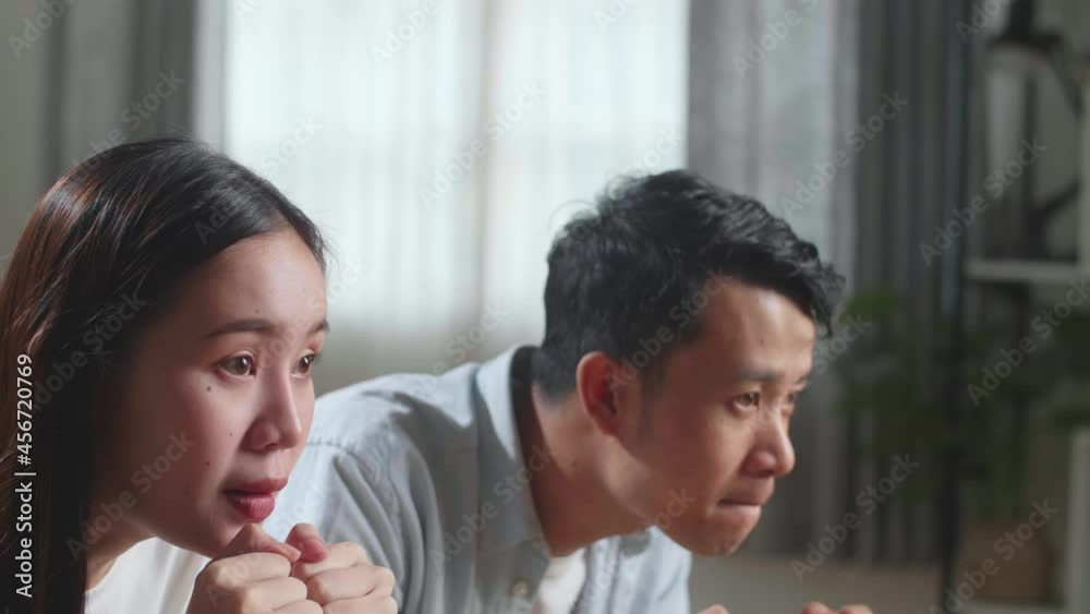 Excited Asian Couple Watching Tv Together Sitting On A Sofa In The Living Room At Home
Excited Asian Couple Watching Tv Together Sitting On A Sofa In The Living Room At Home