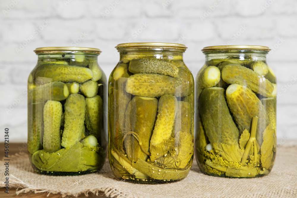 Homemade canned food. Pickled snacks for the winter. Pickled cucumbers with herbs and spices in glass jars. Homemade canned food. Pickled snacks for the winter. Pickled cucumbers with herbs and spices in glass jars.