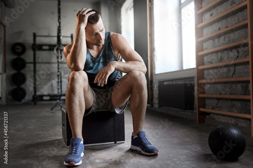 Fototapeta Naklejka Na Ścianę i Meble -  sport, bodybuilding, fitness and people concept - tired young man with medicine ball in gym