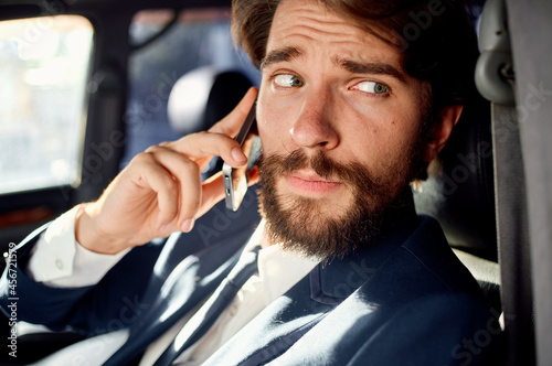 business man in the car talking on the phone passenger