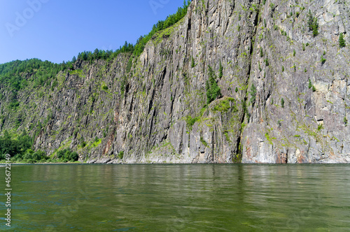 High steep rocky bank of a river. photo