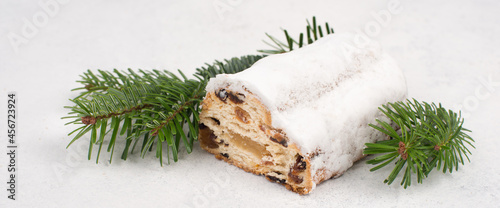 Christstollen, traditonal christmas cake with nuts, raisons, marzipan on a blue background photo