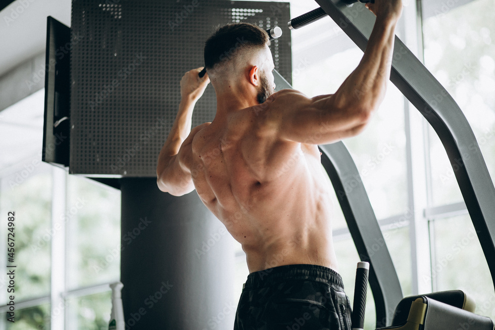 Handsome man bodybuilder doing workout at gym Handsome man bodybuilder doing workout at gym
