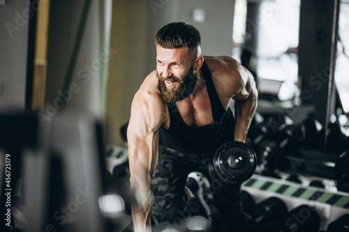 Fototapeta Naklejka Na Ścianę i Meble -  Handsome man bodybuilder doing workout at gym