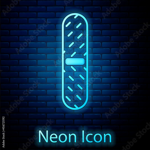 Glowing neon Nail file icon isolated on brick wall background. Manicure tool. Vector