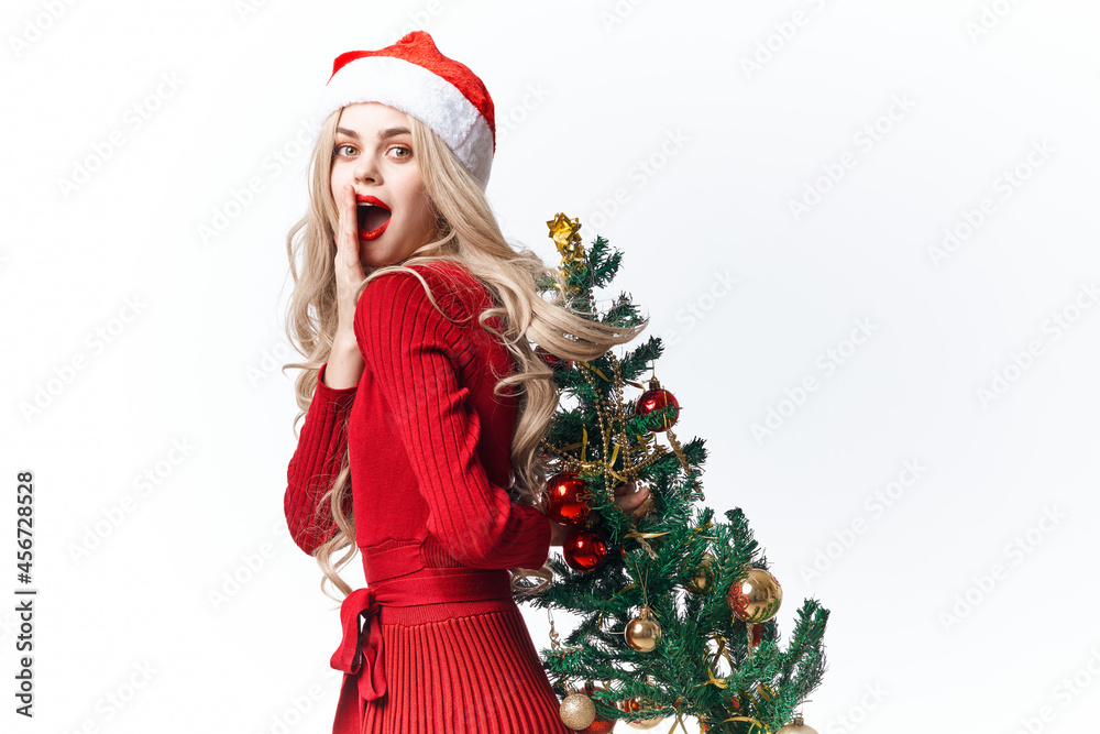 woman wearing santa hat christmas tree decoration holiday light background