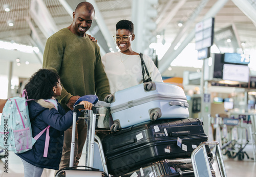 African family at airport standing with luggage