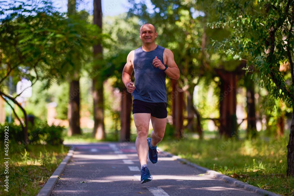 Man running in nature through the park, sports in the city. Man running in nature through the park, sports in the city.