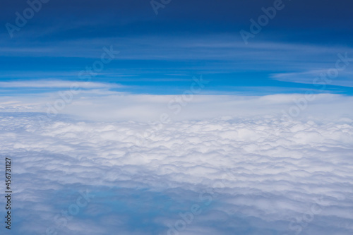 Aerial view scene of the white fluffy clouds and blue bright sky background.