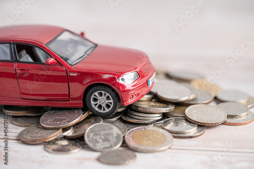 Car on coins background; Car loan, Finance, saving money, insurance and leasing time concepts.