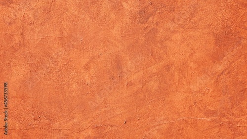 Orange plastered wall as a texture with copy space
