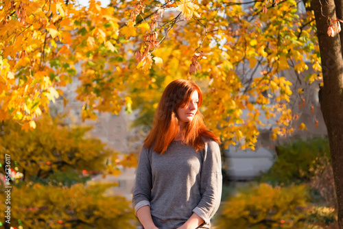 Redhead woman in autumn park