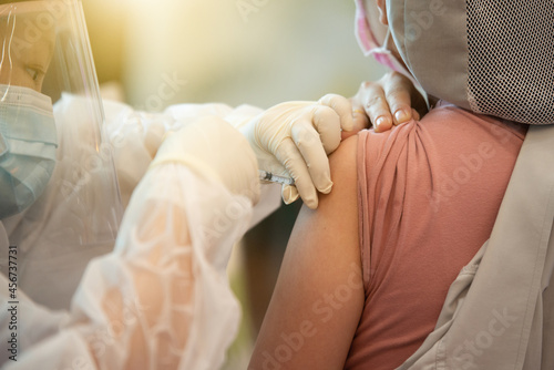 Doctors vaccinate the general public, doctor vaccinating covid 19 to the group of workers , inject a Vaccine Covid19 vaccination for covid 19 for the group of workers