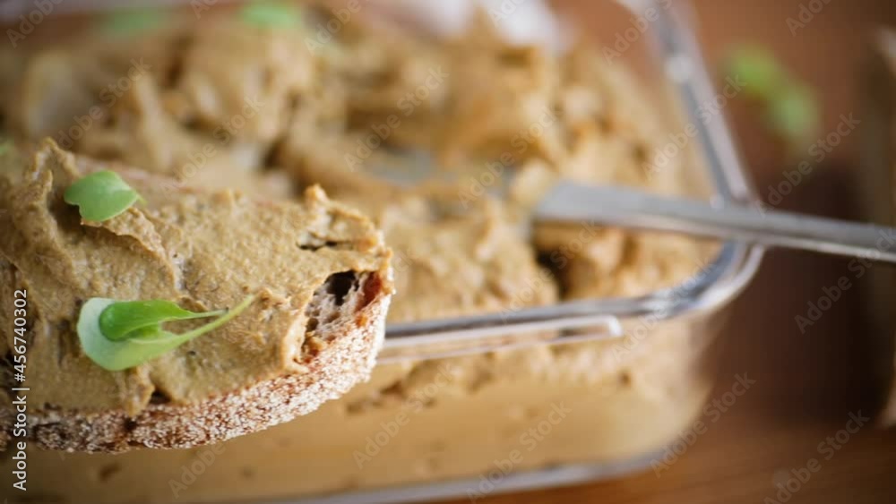 homemade liver pate with bread on a wooden table