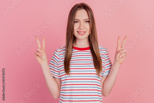 Photo of gorgeous nice attractive lady show v-sign toothy beaming smile on pink background
