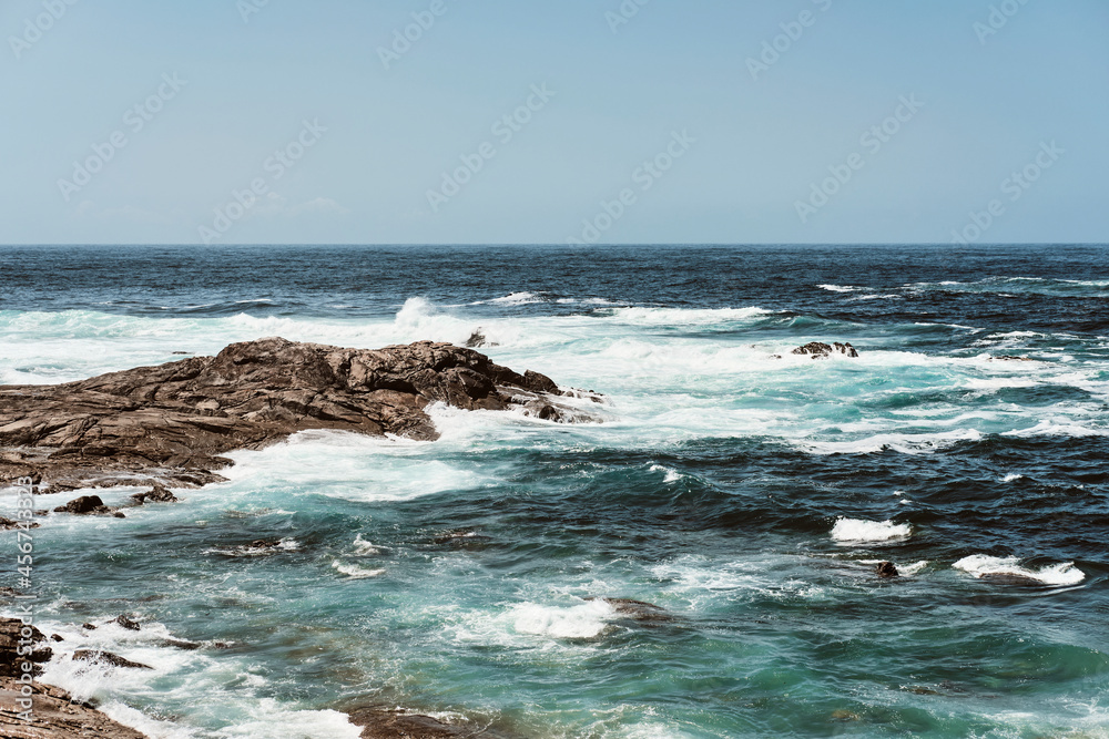 Rough sea landscape with rocks on the shore Rough sea landscape with rocks on the shore