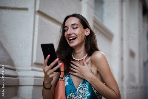 Beautiful young elegance woman using the phone. Beautiful fashion woman talking to the phone