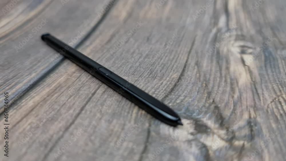 The Black stylus from a mobile device. Digital stylus close-up. The Black stylus from a mobile device. Digital stylus close-up.