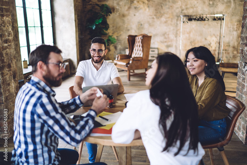фотографія Happy diverse colleagues playing group game in modern workspace