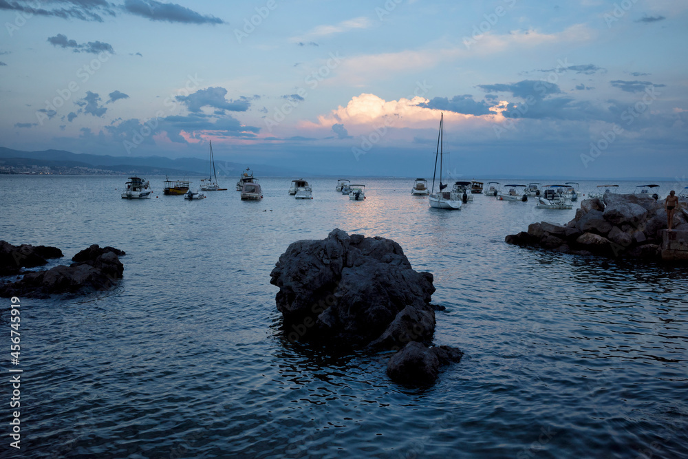 Rijeka, Croatia - August 11, 2021: Resort on the Adriatic Sea. View of the evening seashore, boats and boats in the bay