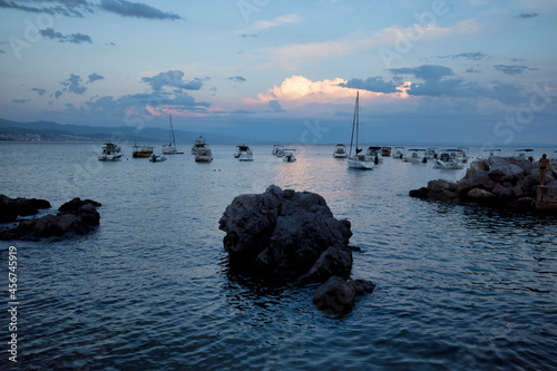 Obraz na płótnie Rijeka, Croatia - August 11, 2021: Resort on the Adriatic Sea. View of the evening seashore, boats and boats in the bay w salonie