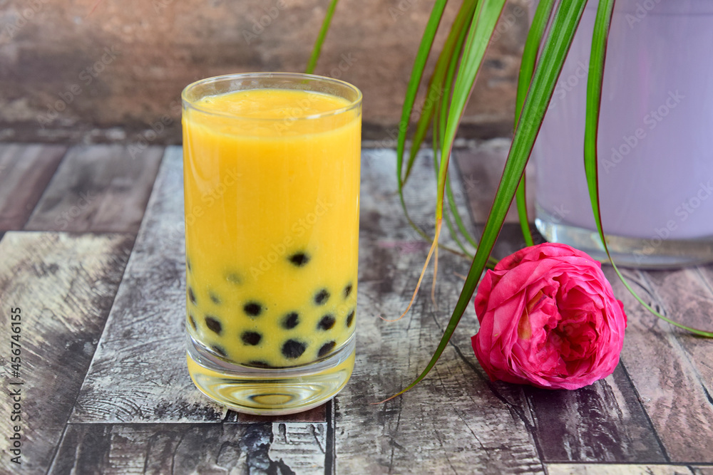 Homemade Mango bubble tea, made with mango milk and palm sugar boba