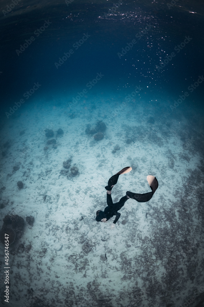Freediver Men Doing Apnea in the blue ocean clear water like great barrier reef