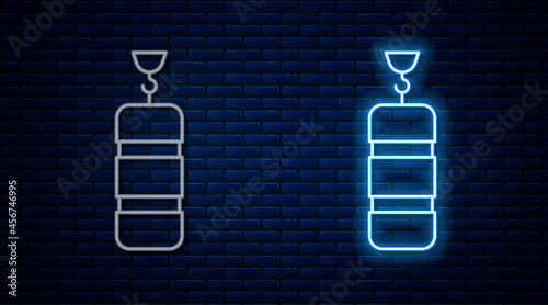 Glowing neon line Punching bag icon isolated on brick wall background. Vector