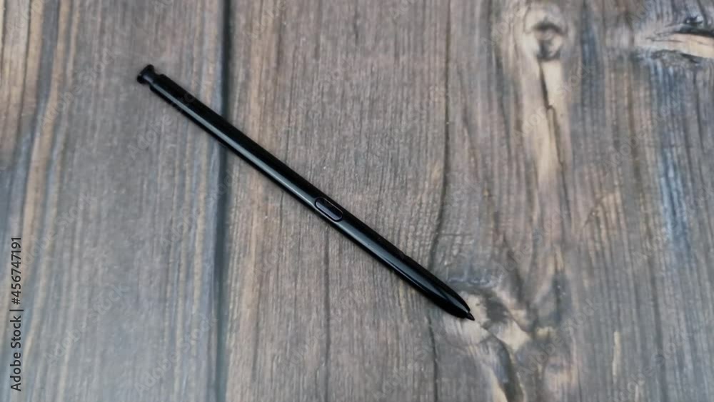 The Black stylus from a mobile device. Digital stylus close-up. The Black stylus from a mobile device. Digital stylus close-up.