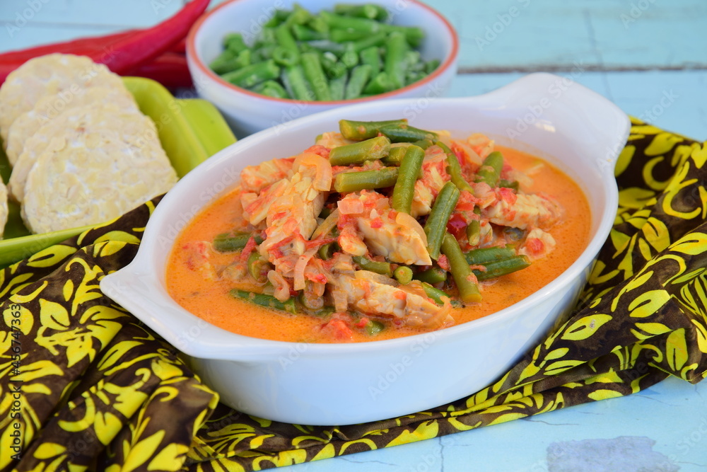 Sayur tempe buncis. Tempeh and green bean cooked in spices and coconut milk. Indonesian food. Served with rice Sayur tempe buncis. Tempeh and green bean cooked in spices and coconut milk. Indonesian food. Served with rice