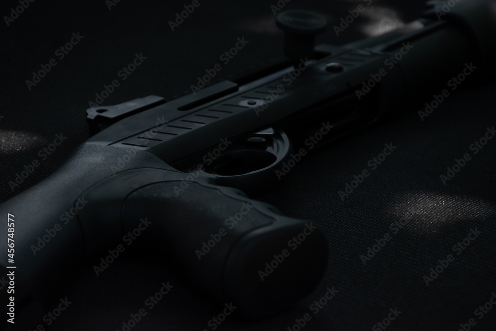 Closeup view of shotgun on a black leather background