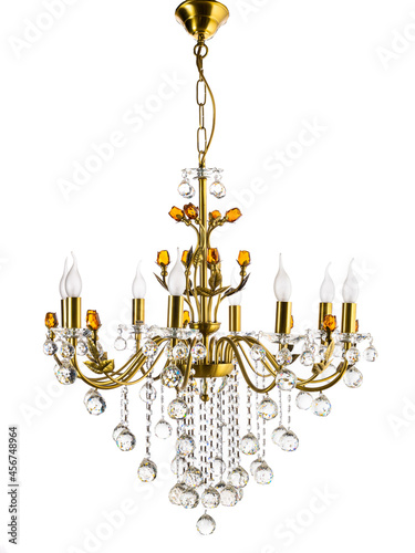 yellow gold chandelier with decorations hanging on a white background