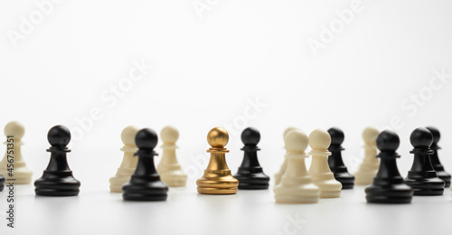 Golden Chess pawn standing to Be around of other chess, Concept of a leader must have courage and challenge in the competition, leadership and business vision for a win in business games