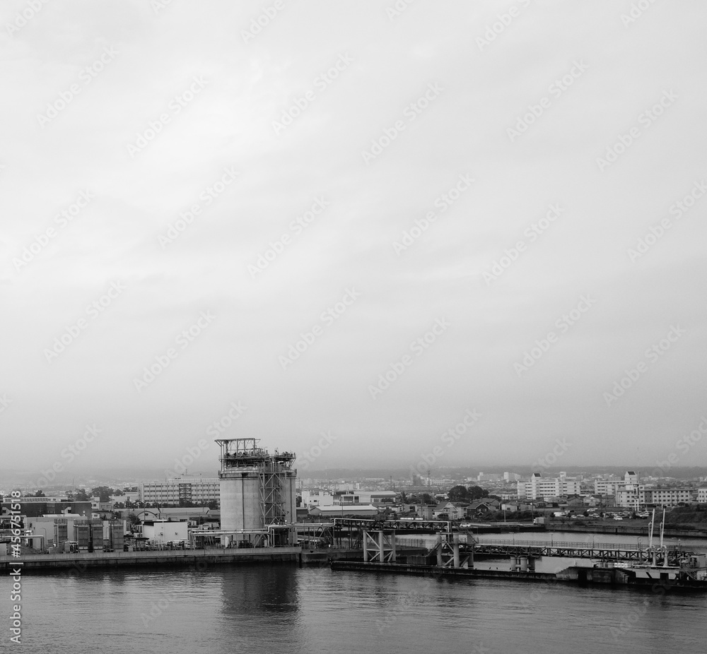 Fototapeta premium Coastal industrial district buildings skyline with moody sky at Hakodate port in Hokkaido, Japan