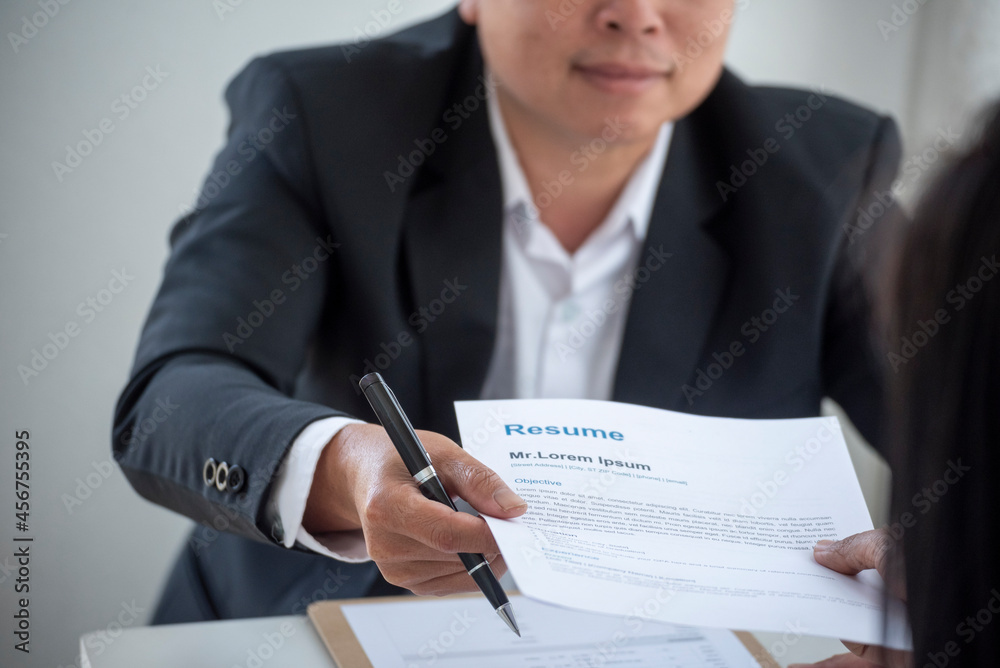 Businessman job interview by human resource HR officer interviwing, talk new employee shaking hands in office with smiling face. HR Manager interview check resume, face to face. Job Interview Concept Businessman job interview by human resource HR officer interviwing, talk new employee shaking hands in office with smiling face. HR Manager interview check resume, face to face. Job Interview Concept