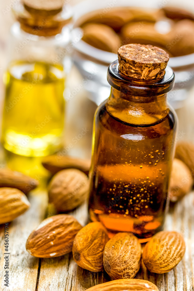 natural oil and almond in cosmetic set on table background natural oil and almond in cosmetic set on table background