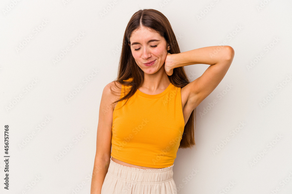 Young caucasian woman isolated on white background having a neck pain due to stress, massaging and touching it with hand. Young caucasian woman isolated on white background having a neck pain due to stress, massaging and touching it with hand.