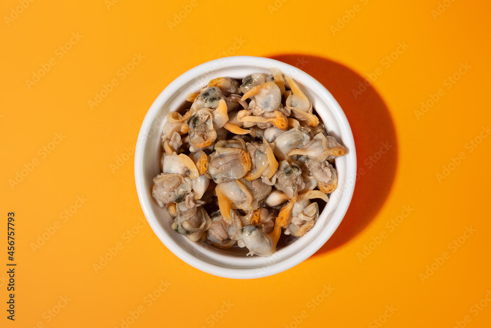 top view plated cockles cap with orange background top view plated cockles cap with orange background
