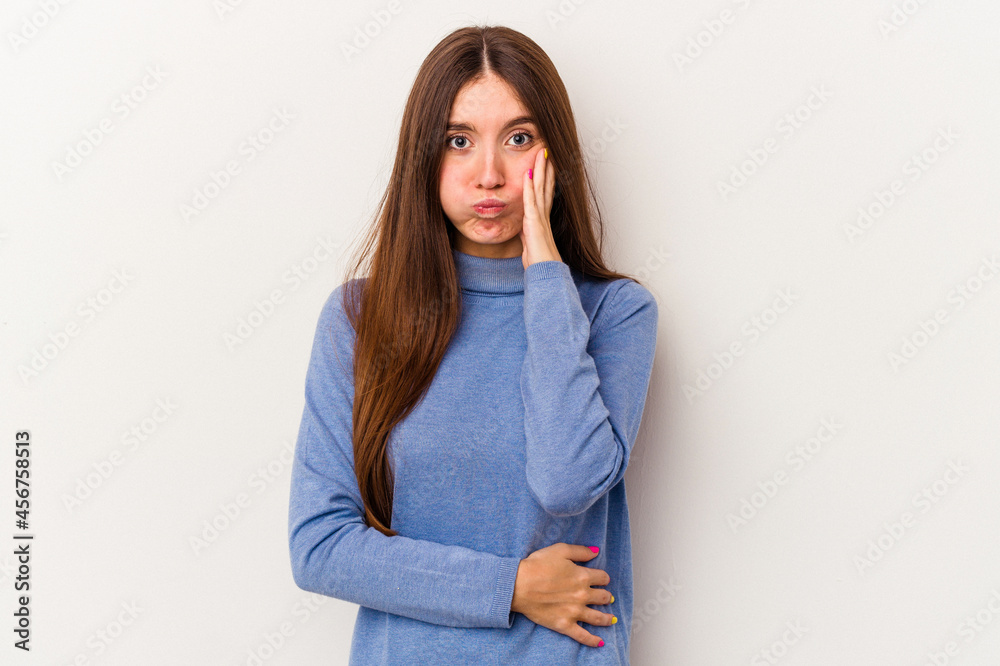 Young caucasian woman isolated on white background blows cheeks, has tired expression. Facial expression concept. Young caucasian woman isolated on white background blows cheeks, has tired expression. Facial expression concept.