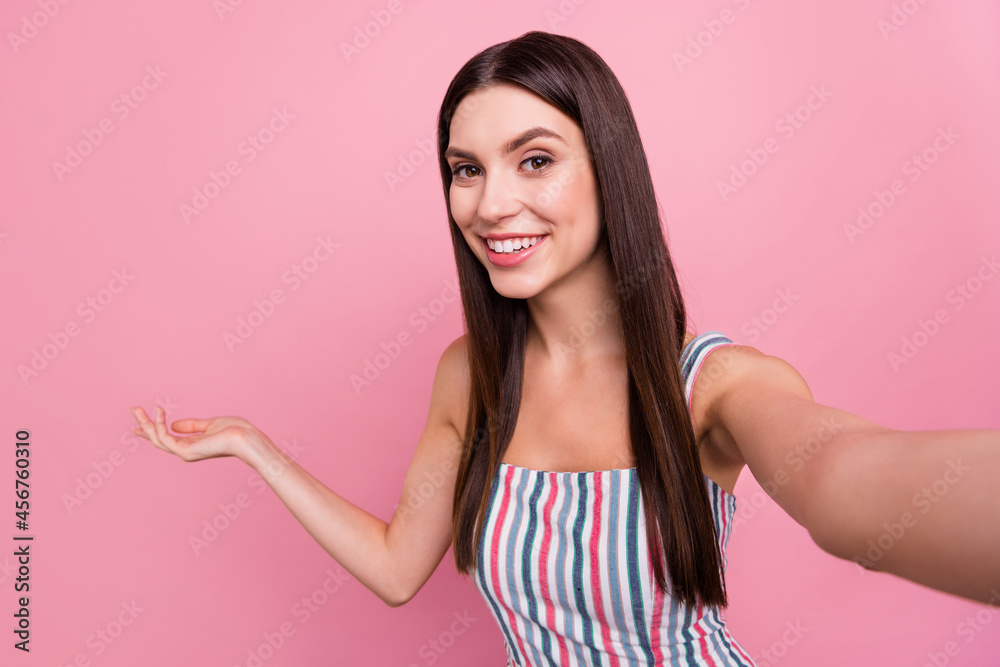 Self-portrait of attractive brown-haired cheerful girl showing copy space invite isolated over pink pastel color background Self-portrait of attractive brown-haired cheerful girl showing copy space invite isolated over pink pastel color background